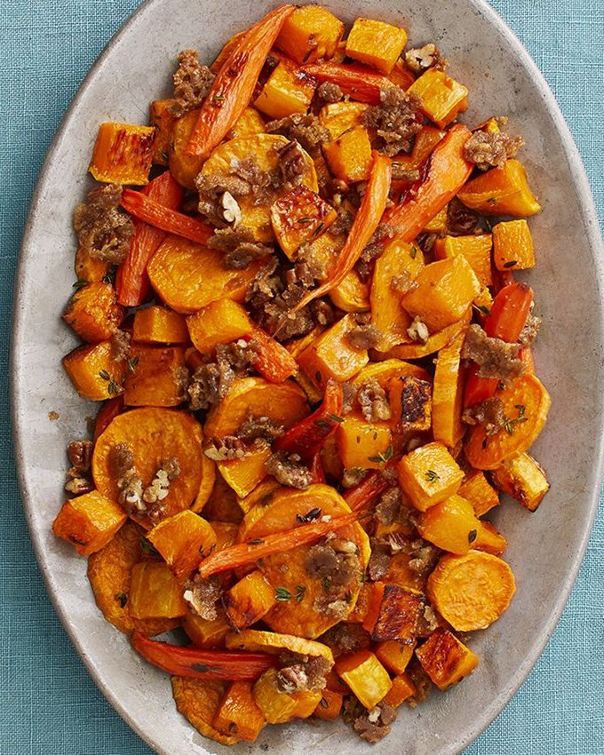 sweet potato recipes roasted vegetables with pecan crumble overhead on blue linen background