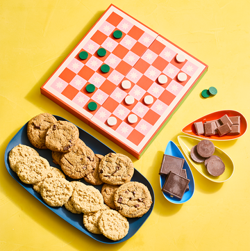 Cookies and chocolates alongside a colorful red boardgame cookies and chocolates alongside a colorful red boardgame