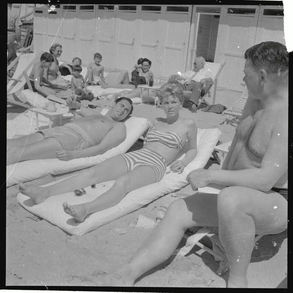 doris day sunning on beach with husband