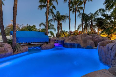 Swimming pool, Resort, Majorelle blue, Vacation, Tree, Leisure, Palm tree, Rock, Arecales, Real estate, 