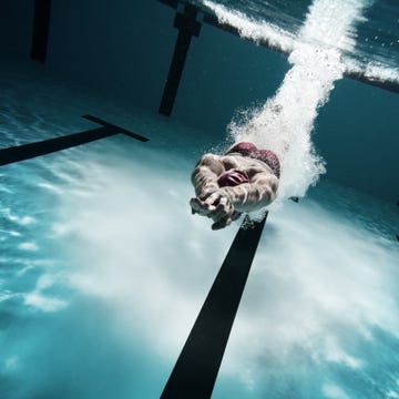 Swimmer diving after the jump in swimming pool