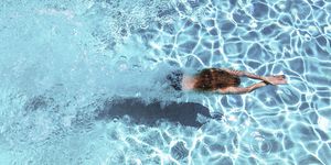 refreshing, woman diving underwater in swimming pool, southern spain
