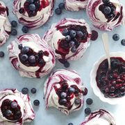 swirled meringues with whipped cream and blueberry sauce