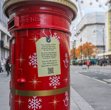 a christmas decorated royal mail postbox in oxford street, london on november 30 2023