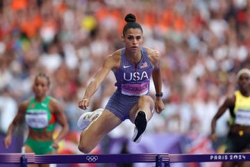 sydney mclaughlin levrone jumps a hurdle during the 2024 paris olympics