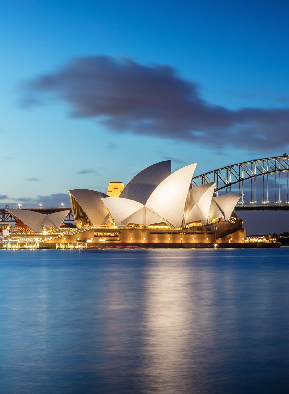 sydney skyline at twilight panorama of the sydney skyline the small sydney opera house on the left side, sydney harbor bridge in the middle twilight view sydney panorama sydney, australia canon 5dsr 50mpixel panorama