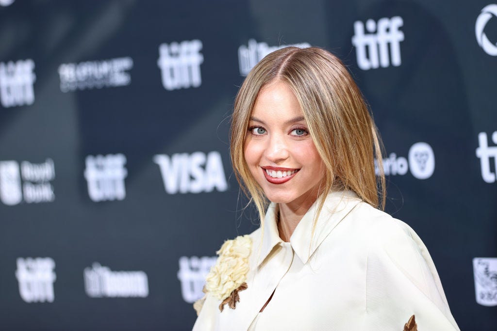 Sydney Sweeney channels preppy chic in plunging three-piece skirt suit