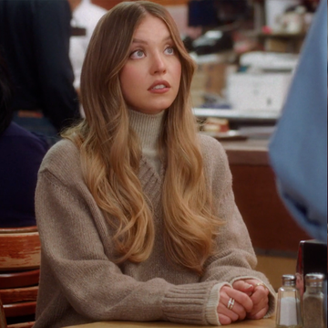 Sydney Sweeney and Meg Ryan two women seated in a diner one with long hair and the other holding a sandwich