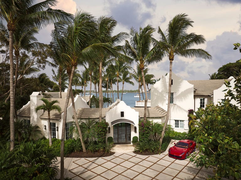 front exterior of spacious white home on palm beach island