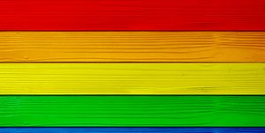 Symbol color of LGBTQ+ on wooden wall background. red orange yellow green blue purple.