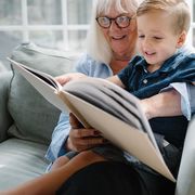 grandmother and grandson looking at photo album