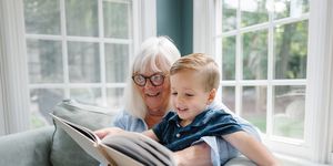 grandmother and grandson looking at photo album
