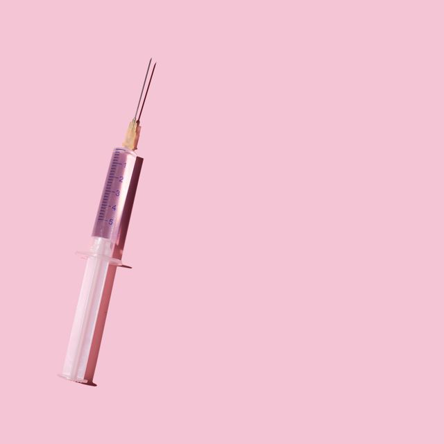 syringe on the pink background