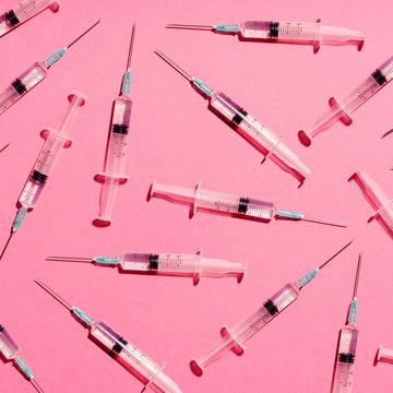 syringe with injection or vaccine repetition pattern on pink background