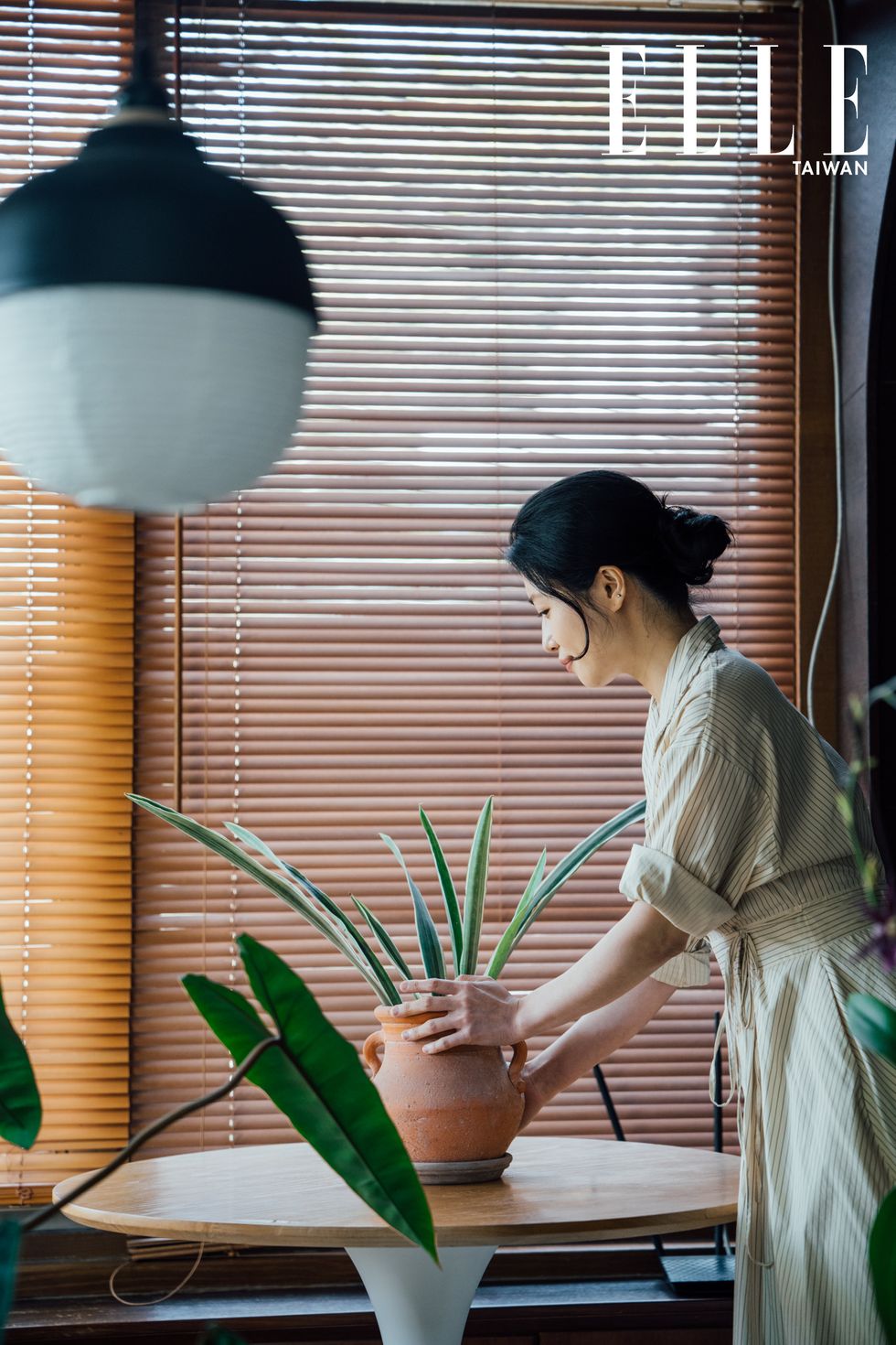 a woman looking at a plant