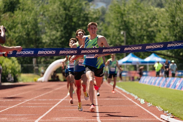 athletes competing in a running race crossing the finish line