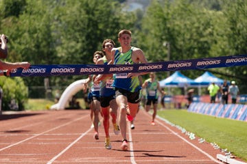 athletes competing in a running race crossing the finish line