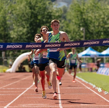 athletes competing in a running race crossing the finish line athletes competing in a running race crossing the finish line