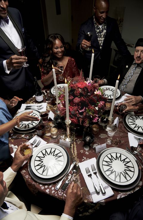 veranda columnist joy moyler holiday supper guests left to right alvin clayton, lisa towles, and stephen plowden raise glasses for a predinner toast decoinspired plates designed by the hostess glassware, saint louis and nasonmoretti for artemest silkbird jacquard table fabric, dedar