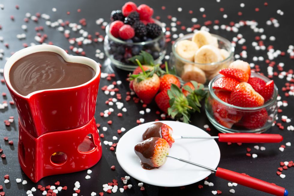 table set for a romantic occasion on valentine's day with chocolate fondue
