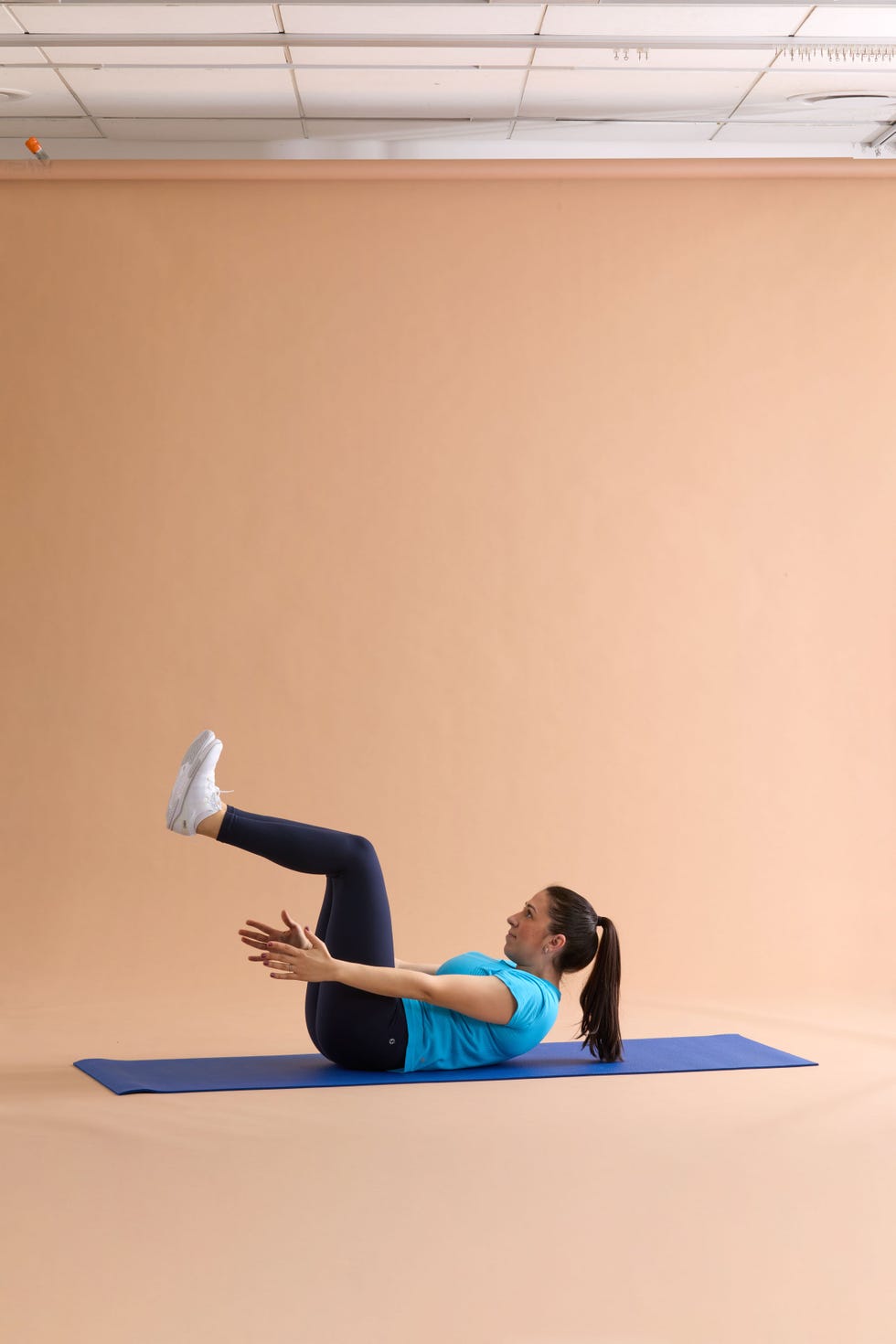 Person performing a workout on a blue yoga mat