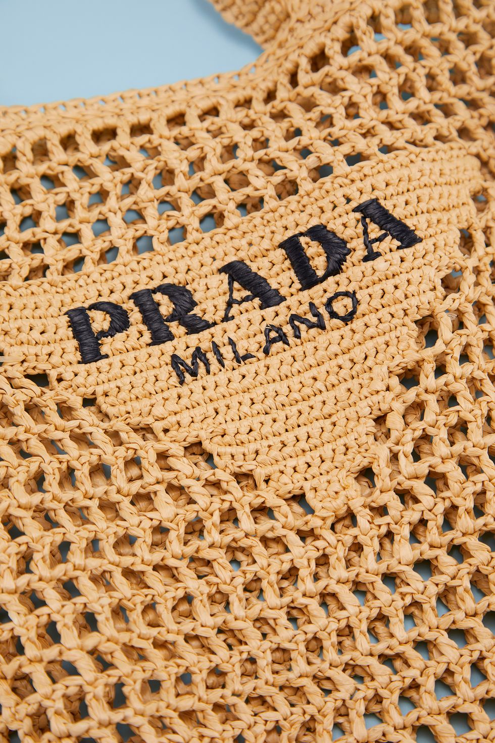 a close up of the raffia weave of the prada crochet tote