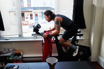 Person exercising on a stationary bike near a window