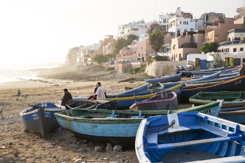 fishermen with boats on the beach at taghazout, morocco
