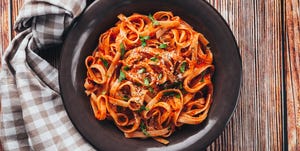 tagliatelle  with tomato sauce on wooden background