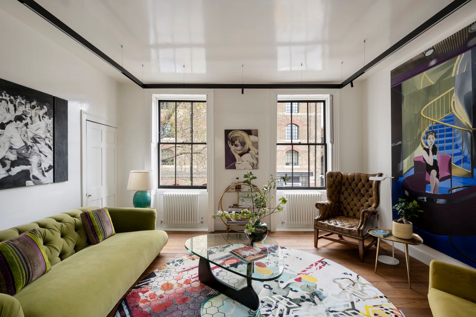 Luxurious living room with green velvet sofa and oval glass table