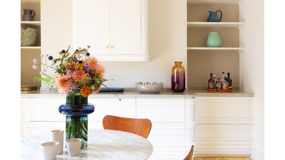 white kitchen-diner with colourful accessories and marble table