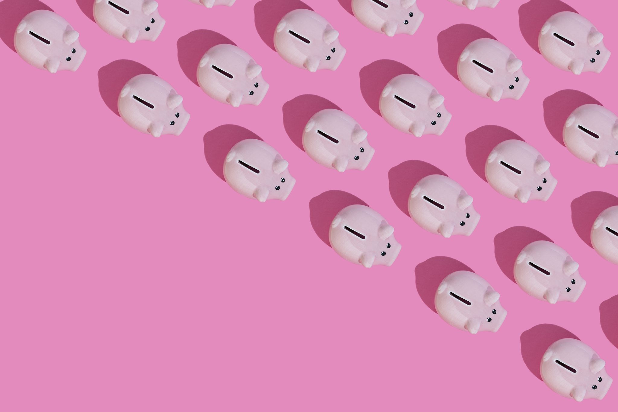 directly above view of some piggy banks on pink background