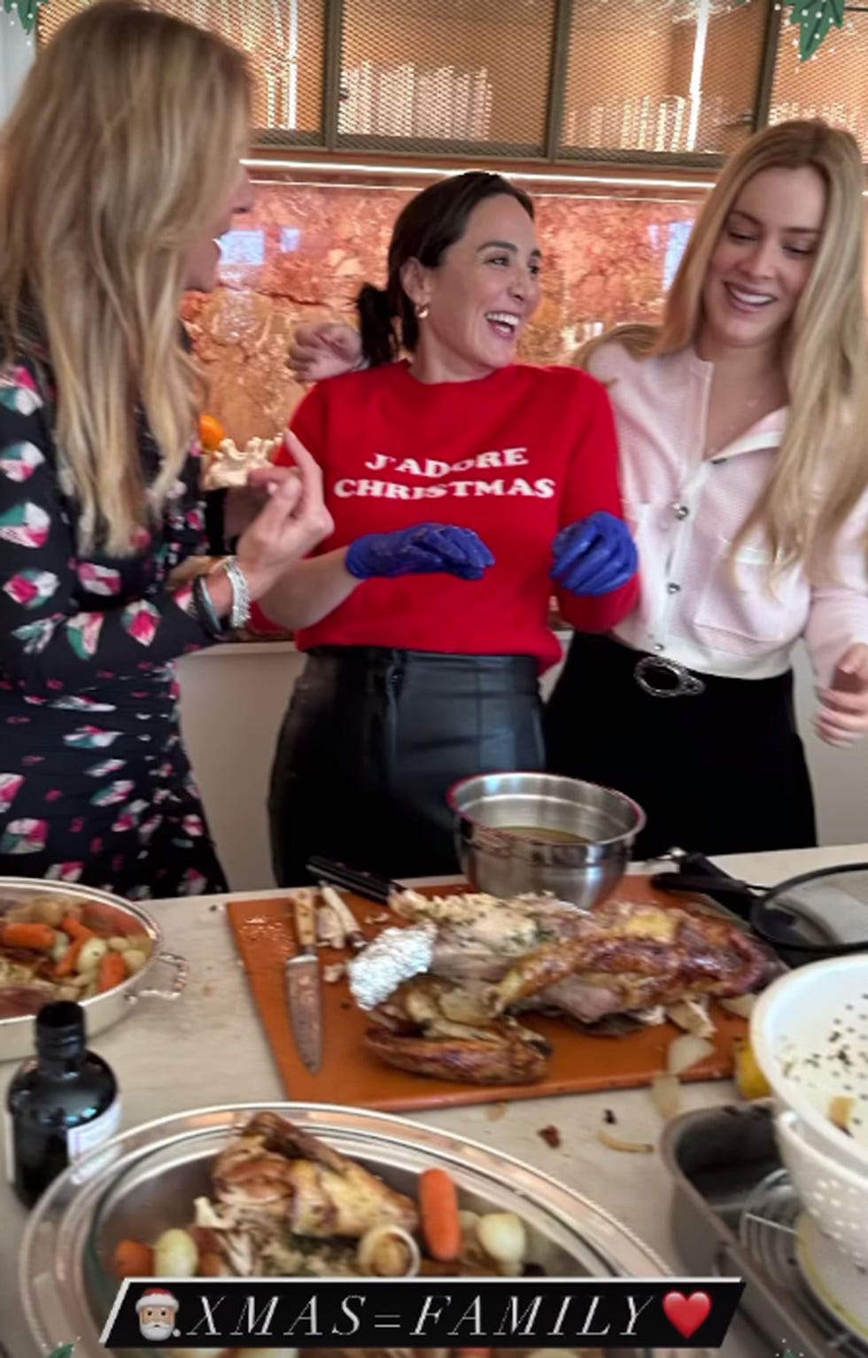 a group of women standing around a table with food on it