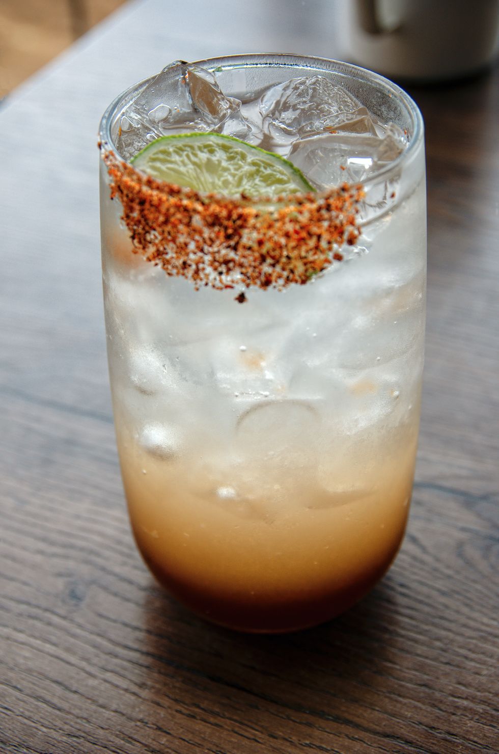 tamarindo soda saborizada (tamarind juice flavored soda) in a drinking glass on a restaurant table
