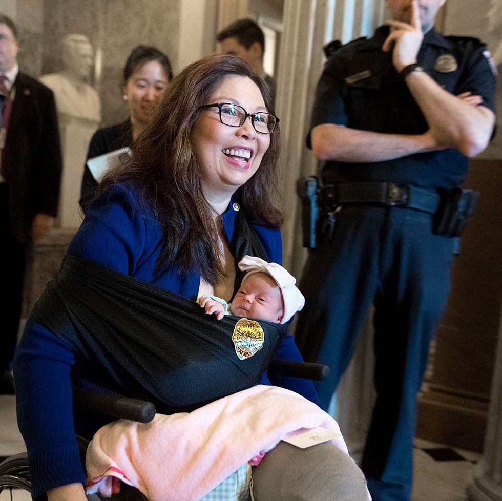 tammy duckworth leaves the senate chamber after a vote with her newborn baby daughter maile pearl bowlsbey at the us capitol
