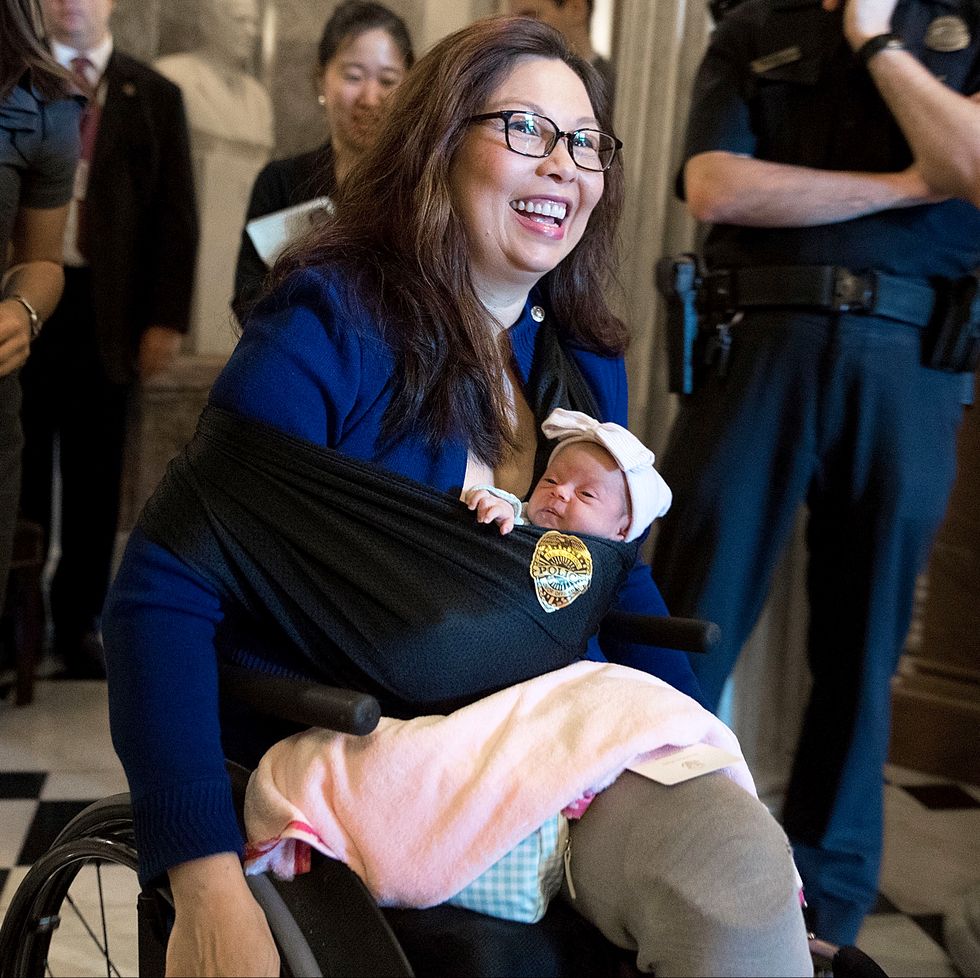 tammy duckworth leaves the senate chamber after a vote with her newborn baby daughter maile pearl bowlsbey at the us capitol