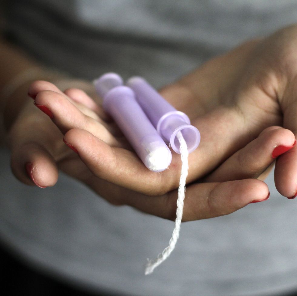 close up of woman hand holding tampons