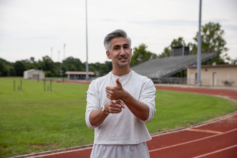 tan france on a track field in queer eye season 8