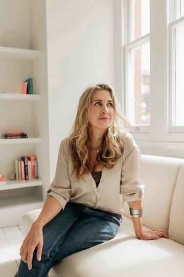 woman seated on a sofa in a bright modern room
