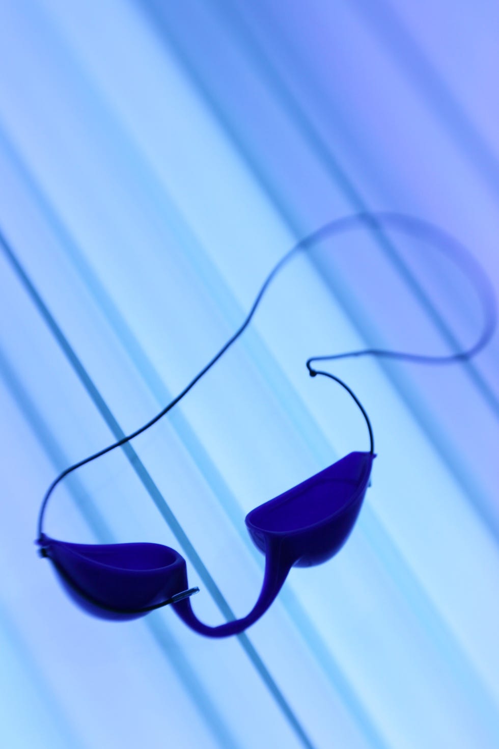 tanning goggles on bed