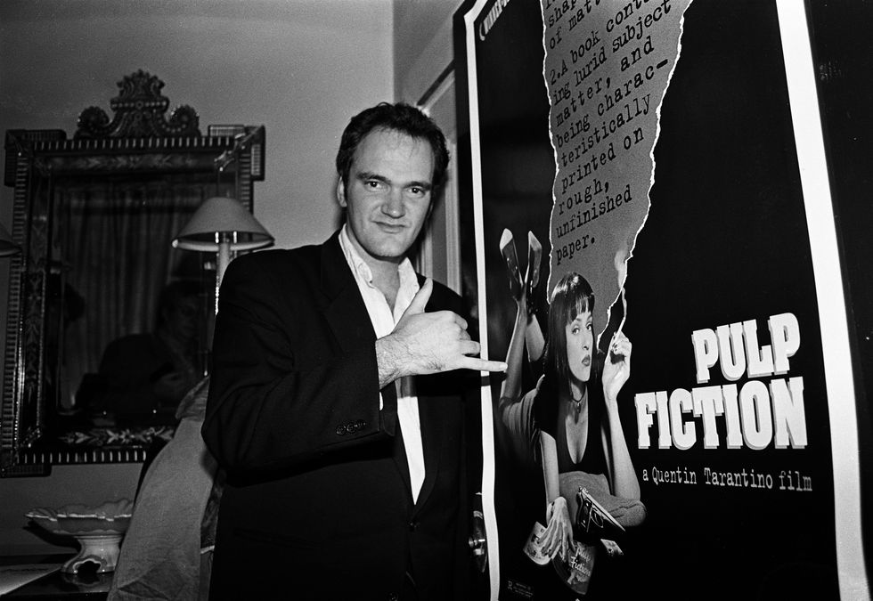 film director quentin tarantino, portrait, standing by a poster for his film pulp fiction, london, united kingdom, 1994 photo by martyn goodacregetty images