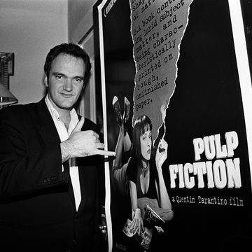 film director quentin tarantino, portrait, standing by a poster for his film pulp fiction, london, united kingdom, 1994 photo by martyn goodacregetty images