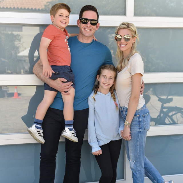 tarek el moussa, his children, and heather rae young in front of their beach house