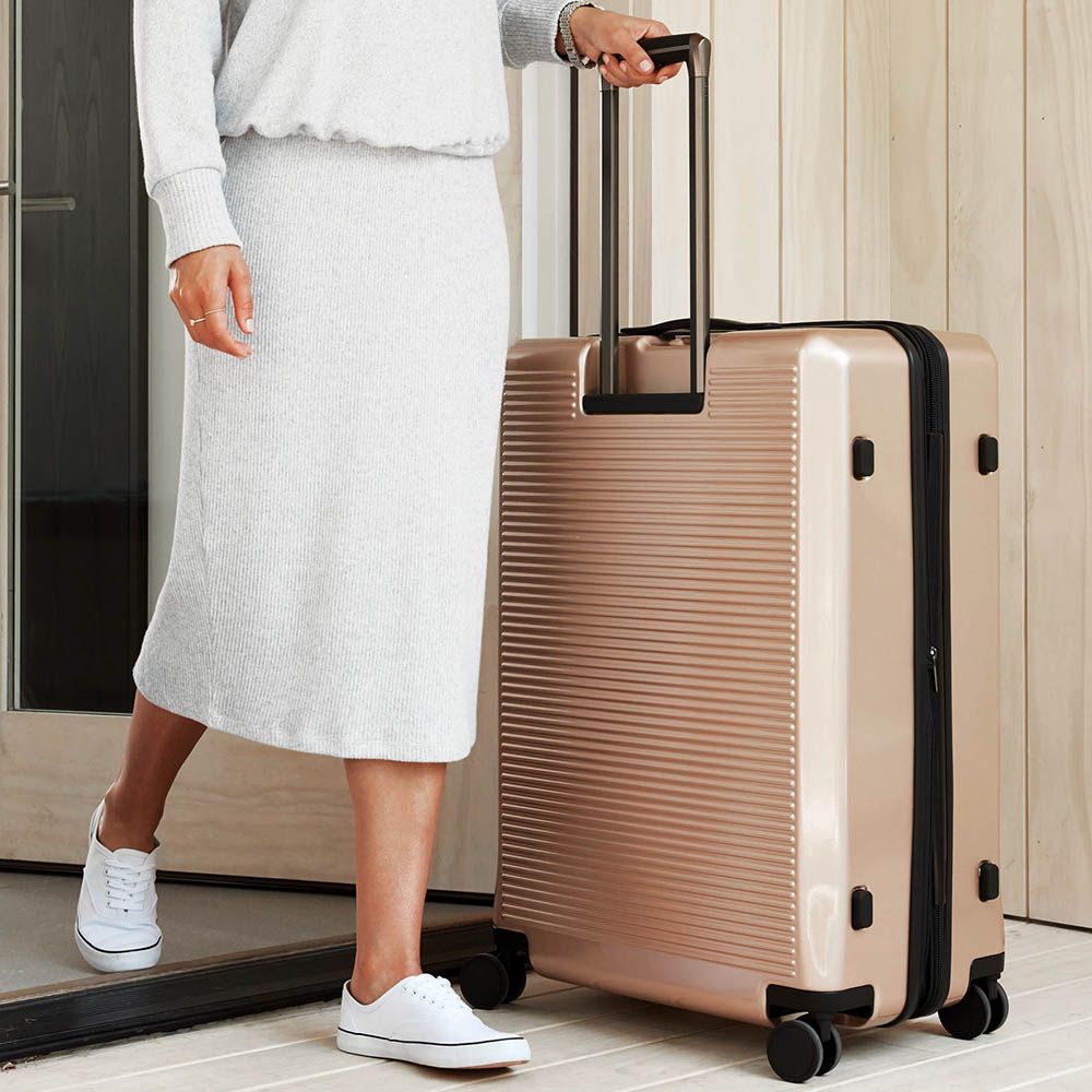 Product, Suitcase, Standing, Hand luggage, Leg, Beige, Luggage and bags, Knee, 