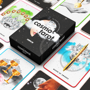 the cosmo tarot deck lies on a white background surrounded by tarot cards