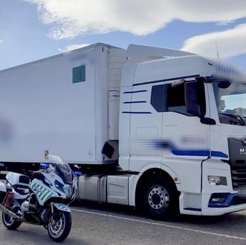 a motorcycle parked next to a semi truck