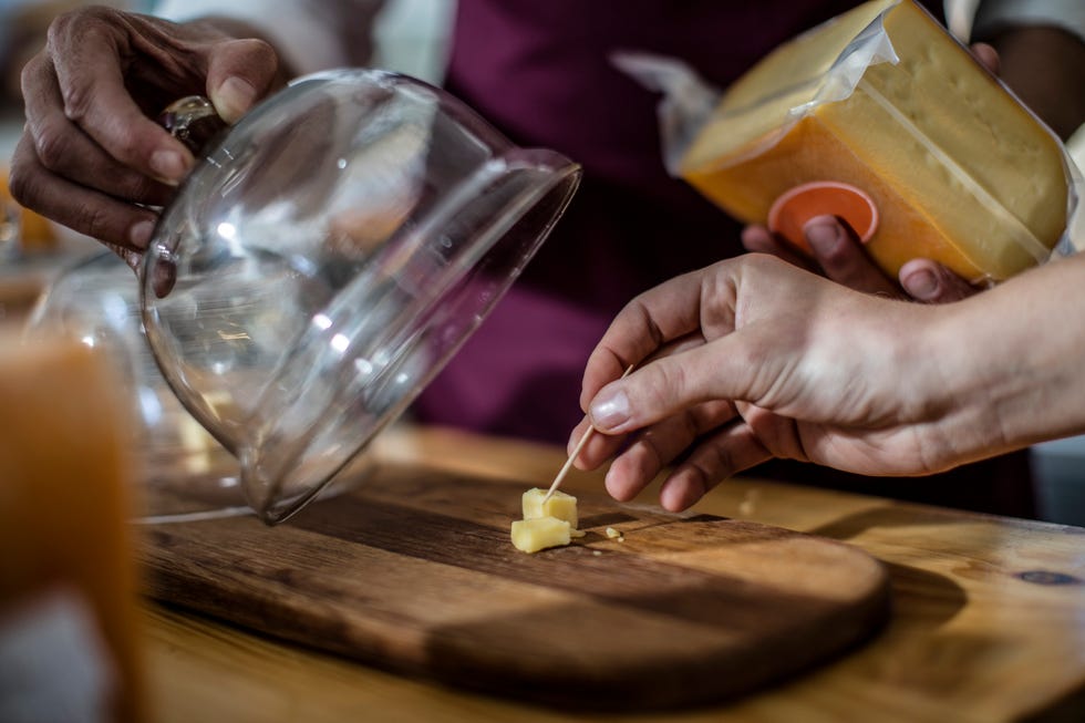 tasting of cheese in farm shop, close up