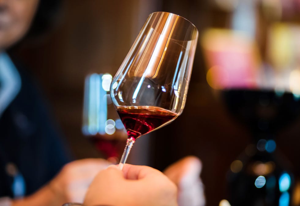 tasting the wine in wineproducer's house focus to the glass with wine