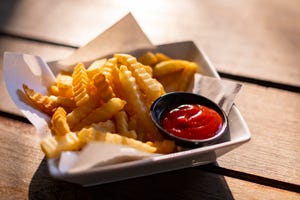 tasty french fries on wooden table