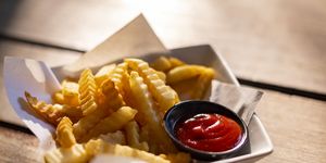 tasty french fries on wooden table